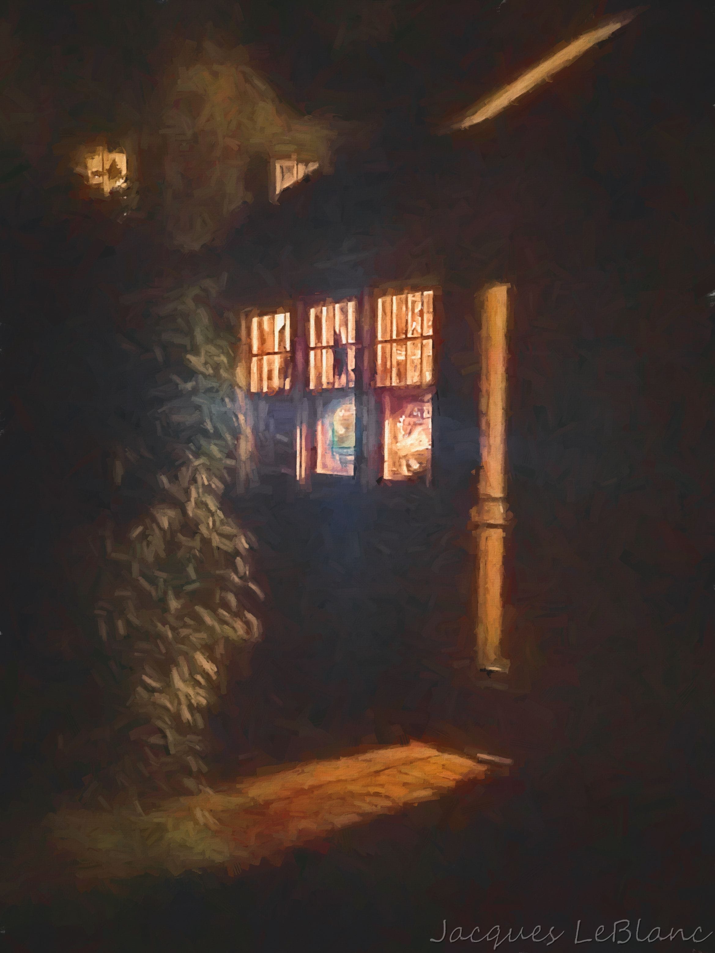 The lights of a workshop flow out of the windows and doors puncture the darkness in glowing red beams. 